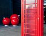 Entrance to the building is decorated with big Christmas balls and phone booth in English style