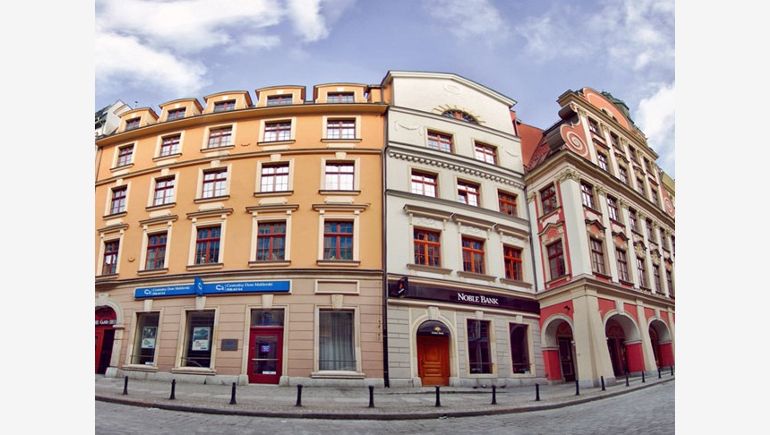 The picture shows the tenement Under Three Oaks