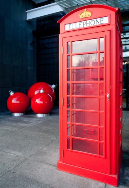  - Entrance to the building is decorated with big Christmas balls and phone booth in English style